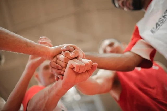 Losing to Win in the NBA in 2006 3 basketball team stacking hands together 3755440