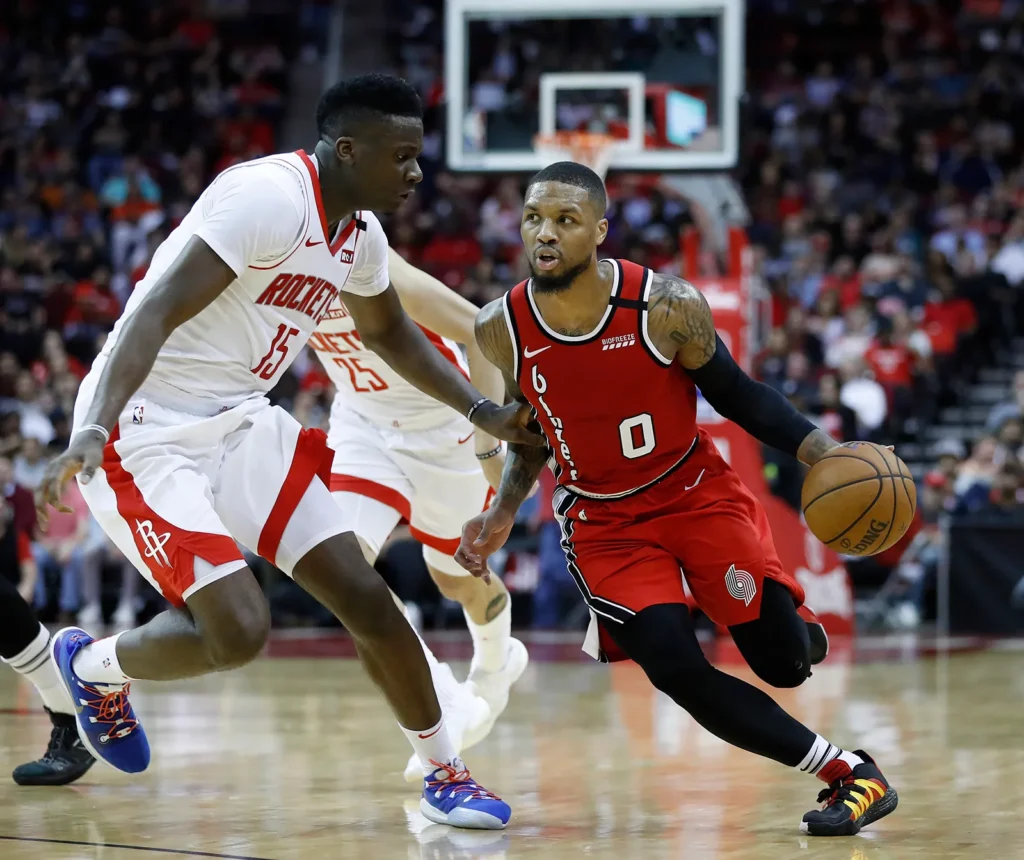 Portland Trail Blazers Guard Damian Lillard Works Around Houston Rockets Center Clint Capela