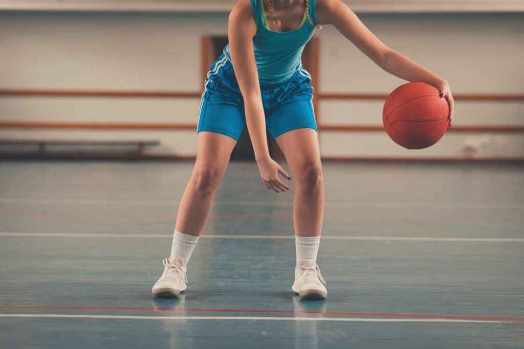 girl dribbling basketball scaled 1