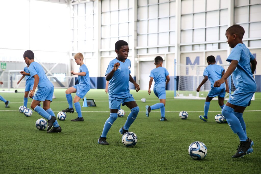 What to Do When Your Kid’s Sports Dreams Come With a Price Tag 2 6107d851b70097bf8995bad8 getty mcfc coaching 11 07 21 16 min